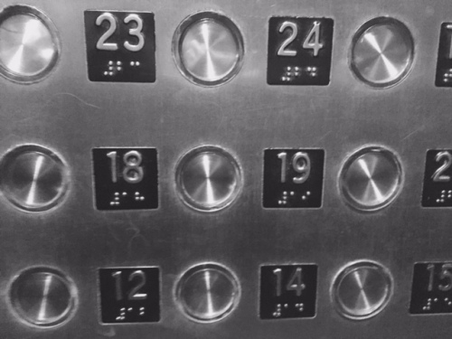 I added a black-and-white filter to the photo to help reduce the glare from this shiny gold elevator panel.